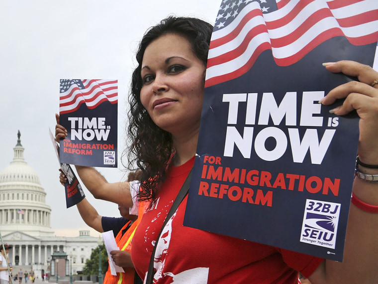 Image: A group of immigrants and activists for immigration reform chant as they march to urge congress to act on immigration reform, on Capitol Hill in Washington