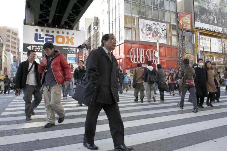 Image: People cross the street in the Akihabara district of Tokyo