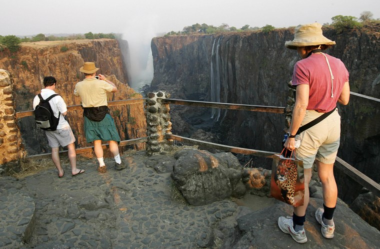 Image: Tourists visit Victoria Falls