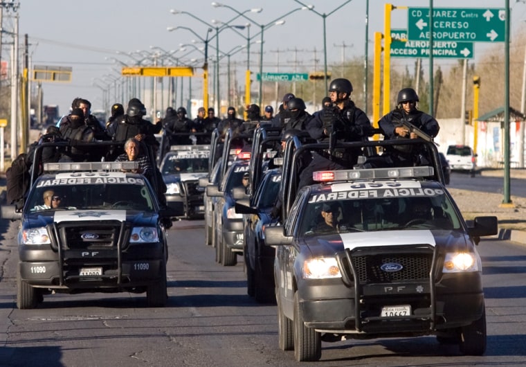 Image: Mexican Federal Police personnel patrol the streets of Ciudad Juarez, near the US border.
