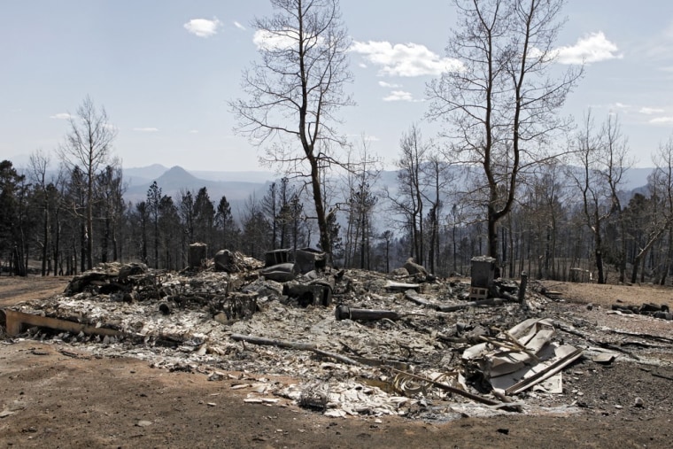 Image: The ruins of a home destroyed by a wildfire are pictured near Conifer, Colo.