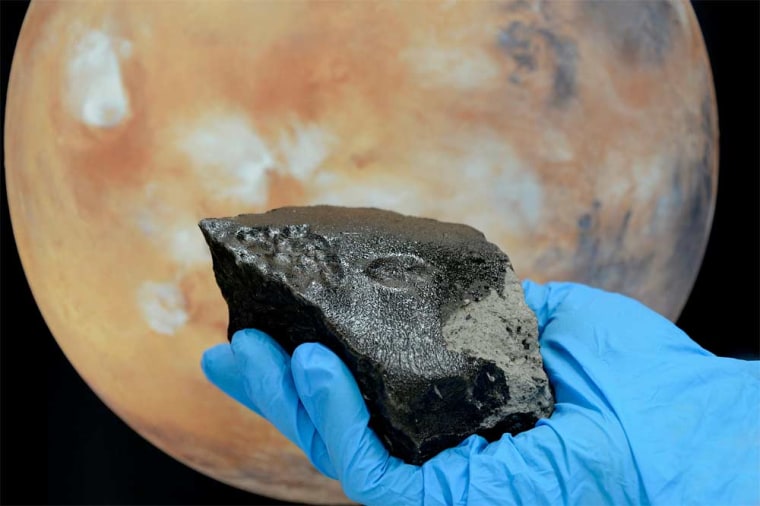 The rear of the stone from the Tissint Martian meteorite is almost completely covered with a glossy black fusion crust.