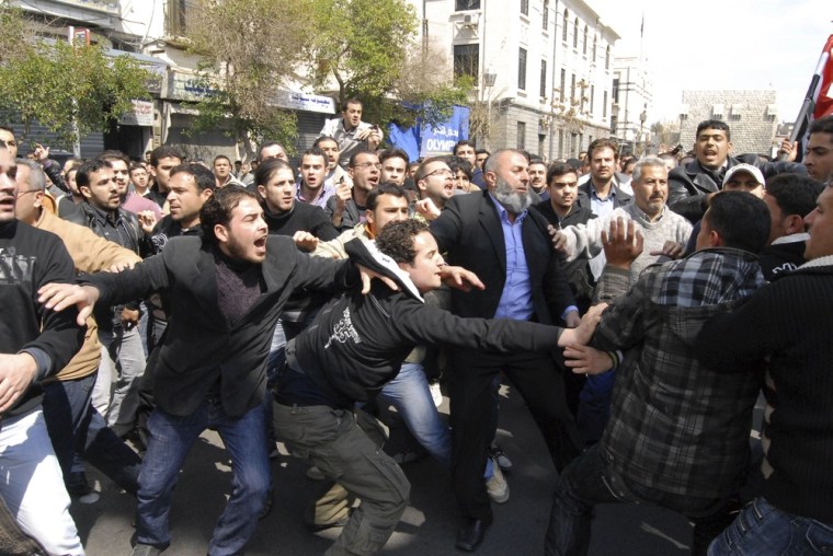 Image: Syrians anti and pro-Assad protesters clash after Friday prayers in Damascus, Syria