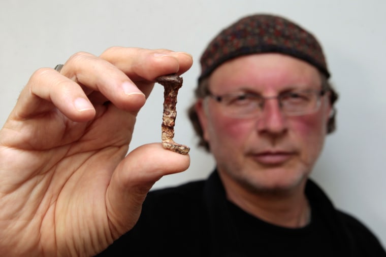 Image: Veteran investigator Jacobovici holds one of the two nails in connection to Jesus, presented in his new documentary film, at Tel Aviv University