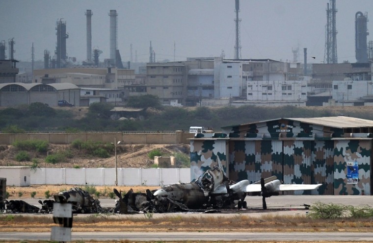 Image: Wreckage of a P-3C Orion aircraft is seen at a major Pakistani naval air base following an attack by militants in Karachi.