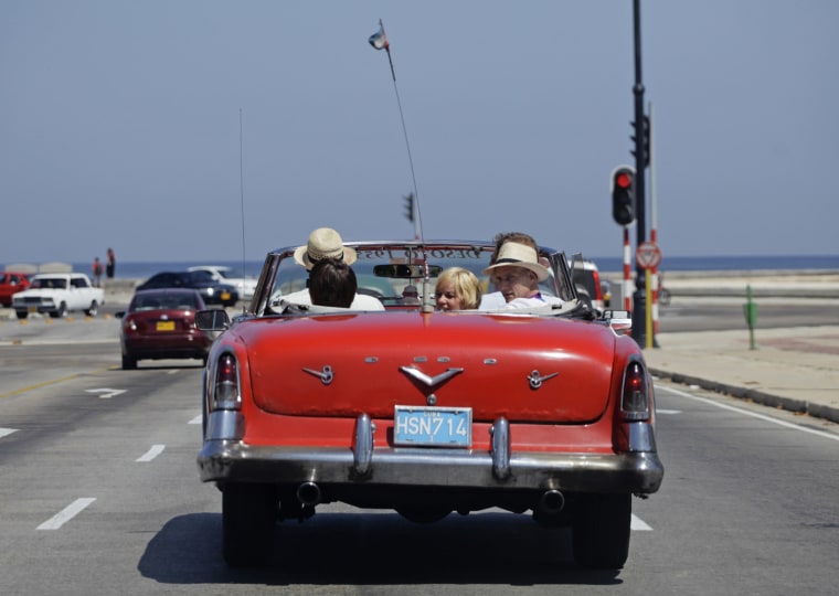 Image: Tourists take a ride in a 1955 Desoto convertible in Havana