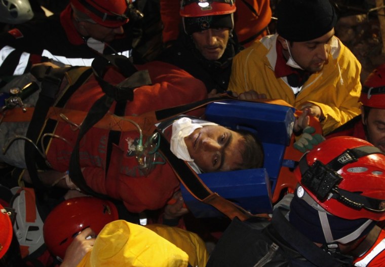 Image: Rescue workers carry 18-year-old male survivor named Imdat from a collapsed building after surviving for more than 100 hours, in Ercis