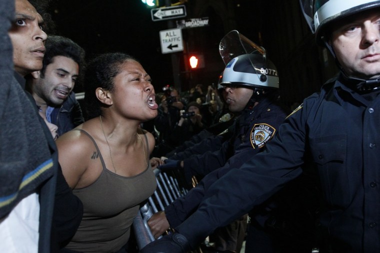 Image: A demonstrator yells at police officers as they order Occupy Wall Street protesters to leave Zuccotti Park, their longtime encampment in New York, early Tuesday.