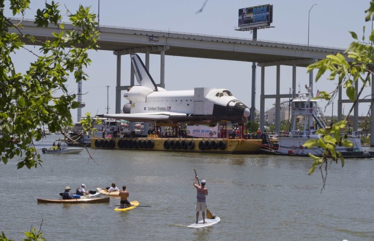 Image: The Space Shuttle replica \"Explorer\" moves by barge into Clear Lake toward the dock at the Johnson Space Center.