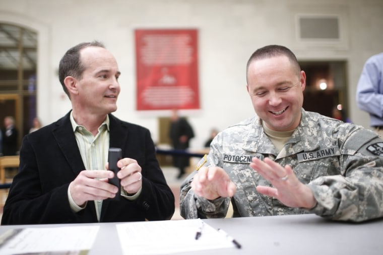 Image: Saunders and U.S. Army Captain Potoczniak look at their marriage license at City Hall in San Francisco