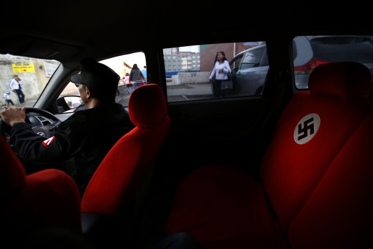 Image: A swastika is seen on the seat of a car belonging to Ariunbold, leader of the Mongolian neo-Nazi group Tsagaan Khass, in Ulan Bator