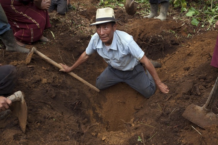 Image: Andres Lopez Sanchez helps forensic anthropologists in the exhumation of a clandestine grave near Ixtupil, Guatemala. Lopez believes his brother Juan, who died in the 1980s during the country's bloody civil war, is buried in this grave.