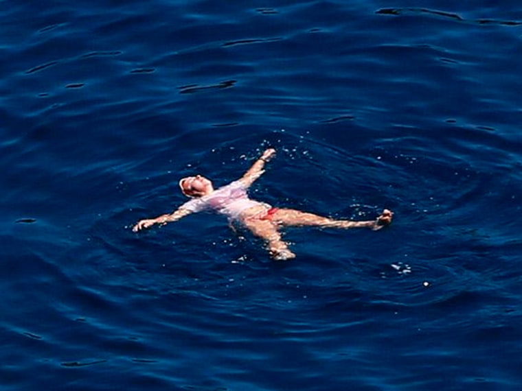 Image: A German tourist bathes in the Aegean sea south of Athens