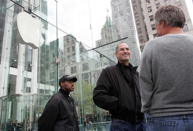 Image: File photo of Apple CEO Jobs looking at crowds at the grand opening of the new Apple Store on 5th Avenue in New York