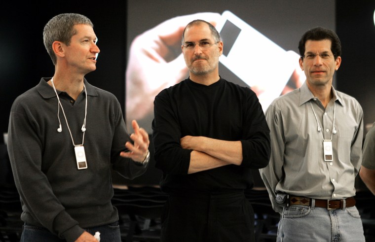 Image: File photo of Apple CEO Steve Jobs posing with Apple Executive Vice-President Timothy Cook and Vice-President Jon Rubinstein