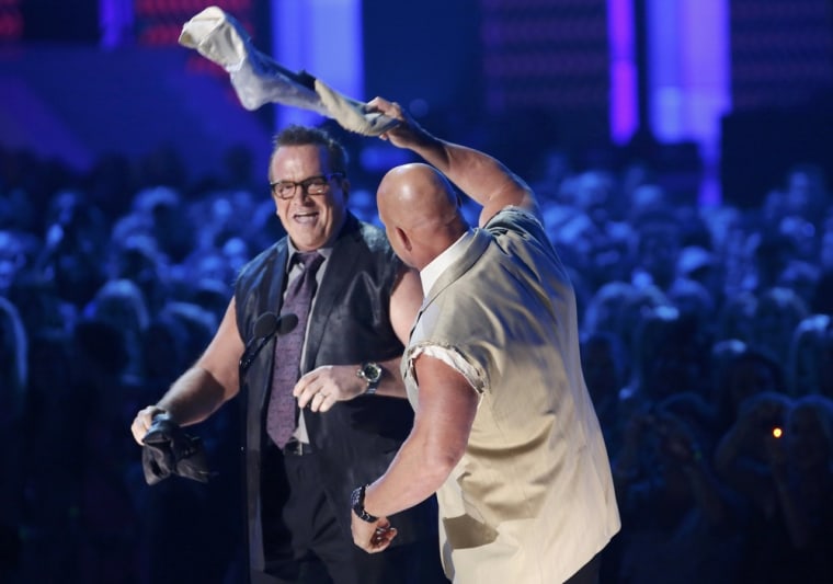 Image: Tom Arnold and Steve Austin react after tearing their sleeves off at the 2012 CMT Music Awards in Nashville