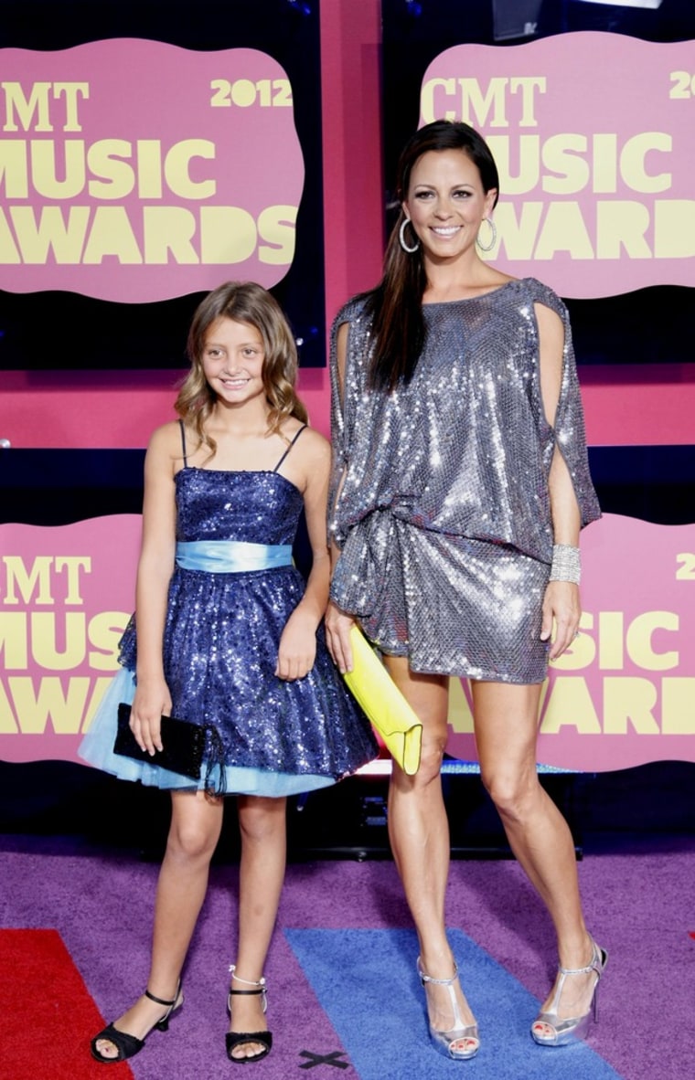 Image: Singer Sara Evans and daughter Olivia arrive at the 2012 CMT Music Awards in Nashville