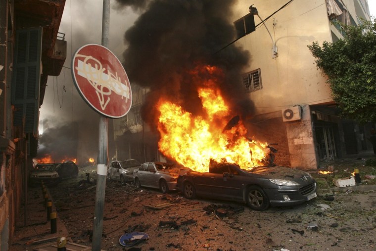 Image: Burning cars and damages are seen at the site of an explosion in Ashafriyeh