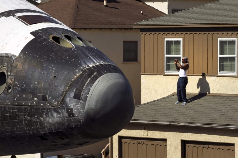 Image: A man takes a photo as Space Shuttle Endeavour travels to the California Science Center in Inglewood, Los Angeles