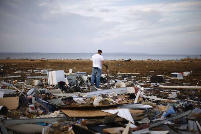 Image: A resident looks through a house that was destroyed by Hurricane Sandy is seen in Union Beach