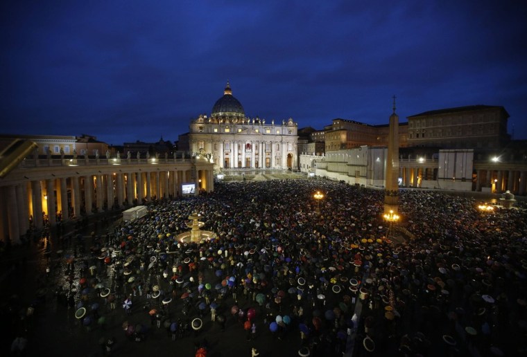 Image: Faithful wait in the rain under umbrellas at Saint Peter's Square at the Vatican