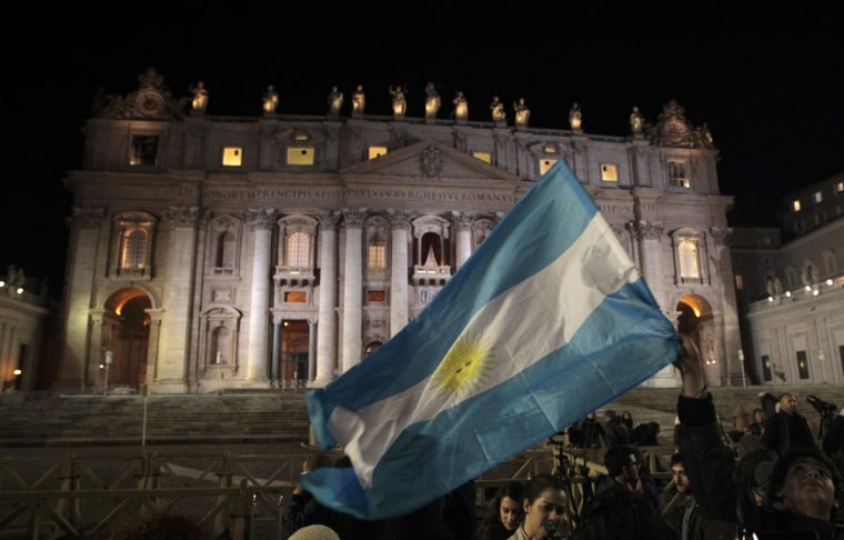 Image: Faithful wave Argentina's flag after white smoke rose from the chimney above the Sistine Chapel indicating a new pope has been elected at the Vatican