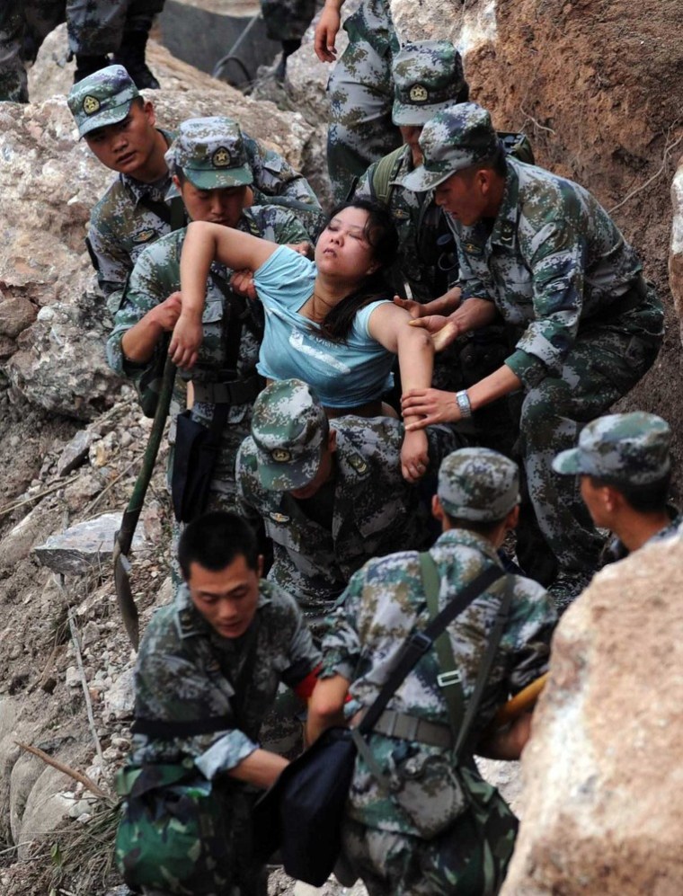 Image: Rescuers save an injured woman after an earthquake hit Baosheng Township in Lushan County, Ya'an City