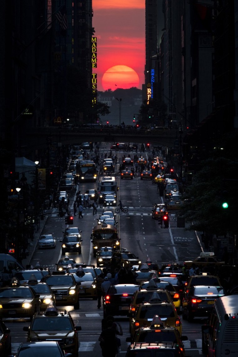 Image: The sun sets along 42nd Street in Manhattan during an annual phenomenon known as \"Manhattanhenge.\"