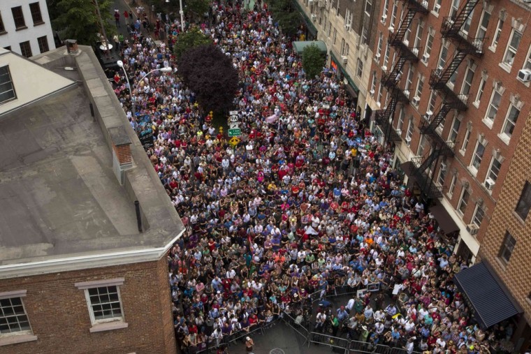 Image: A crowd gathers to listen to speakers near the Stonewall Inn in New York