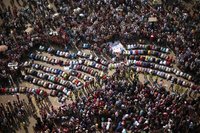 Image: Protesters, opposing Egyptian President Mohamed Mursi, pray during a protest demanding that Mursi resign at Tahrir Square in Cairo