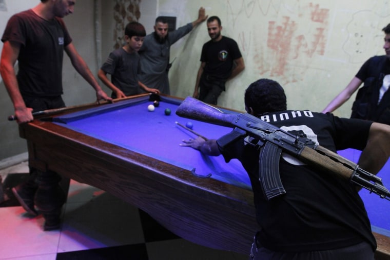 Image: Free Syrian Army fighters play pool as they rest in the old city of Aleppo