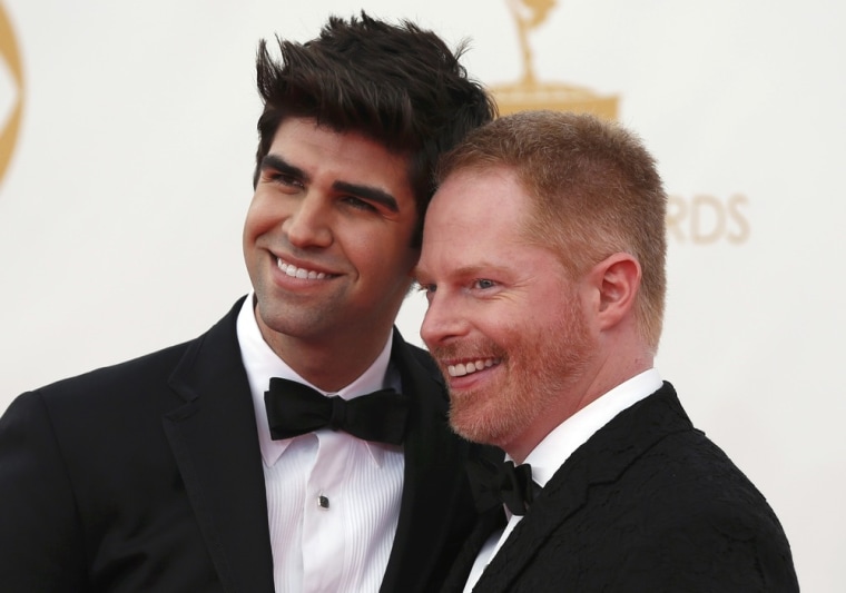 Image: Actor Jesse Tyler Ferguson (R) from the ABC sitcom \"Modern Family\" poses with his husband Justin Mikita as they arrive at the 65th Primetime Emmy Awards in Los Angeles