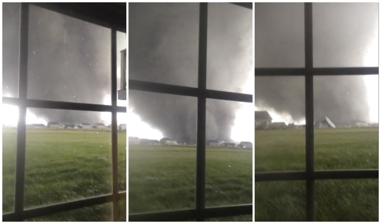 Image: Combination of three video stills shows an active tornado as it touches down in Washington, Illinois