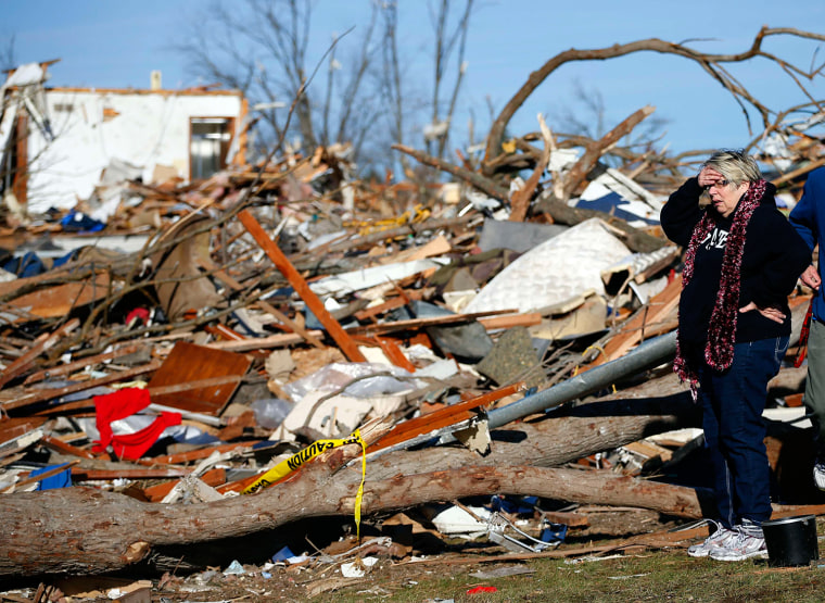 Image: Woman looks at what is left of her home after it was destroyed during a tornado in Washington