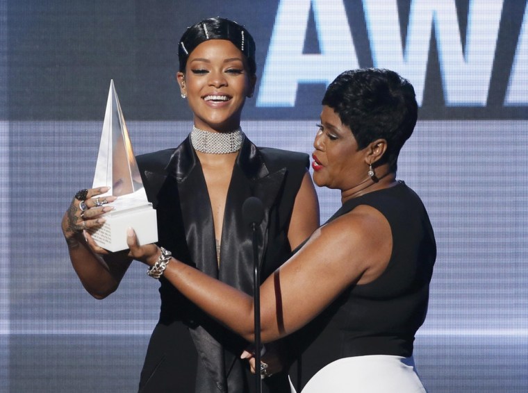 Image: Rihanna accepts the Icon Award from her mother Monica Fenty at the 41st American Music Awards in Los Angeles