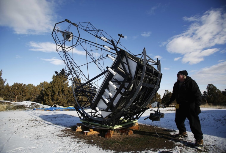 Image: Mike Clements prepares his 35-foot telescope he built in Herriman, Utah