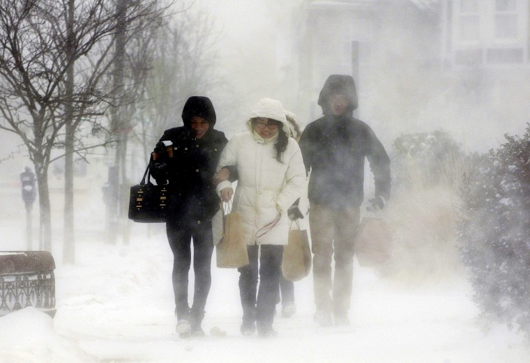 Image: Elmwood Village residents walk down Elmwood Avenue after purchasing needed items from a grocery store in Buffalo