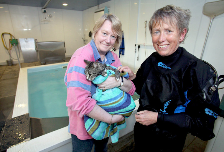 Image: Veronica Ashworth (left) holds her cat, Mog, after a swimming session at Hawksland hydrotherapy pool