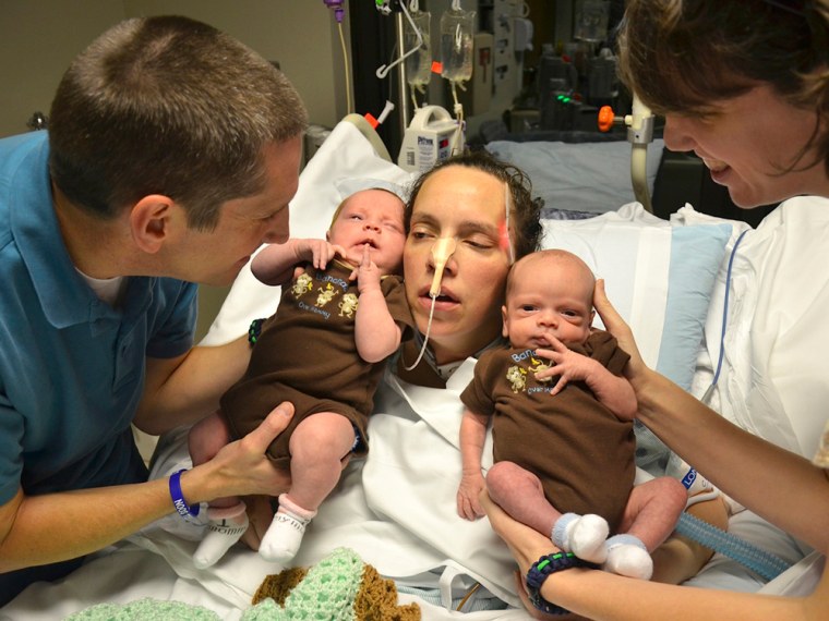 Image: Lana Kuykendall holds her twins Abigail and Ian for the first time since she was admitted to a South Carolina hospital