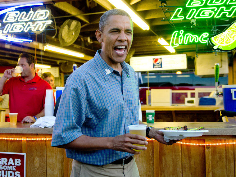 Image: US President Barack Obama (C) gets a bee