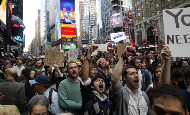 Image: Occupy Wall Street protesters shout slogans during a protest at Times Square in New York