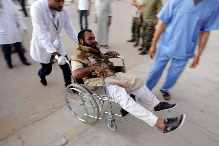 Image: A wounded rebel arrives at Zintan hospital from the battlefield
