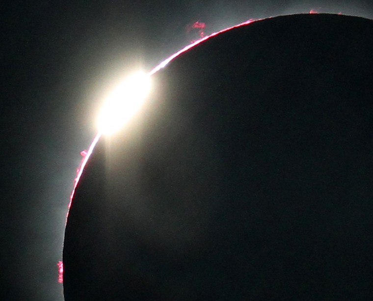 This close-up view of the July 11, 2010, total solar eclipse's second diamond ring reveals a number of prominences as well as the pinkish layer of the sun’s atmosphere called the chromosphere.