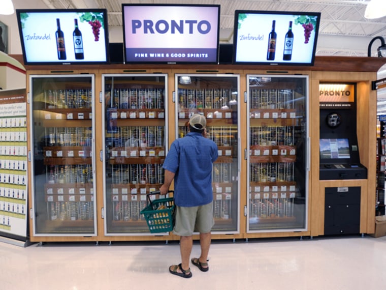 In this June 25, 2010 photo, a shopper inspects the wine offerings from the Pennsylvania Liquor Control Board's self-serve wine kiosk at a Giant food store, in Harrisburg, Pa. (AP Photo/Bradley C Bower)