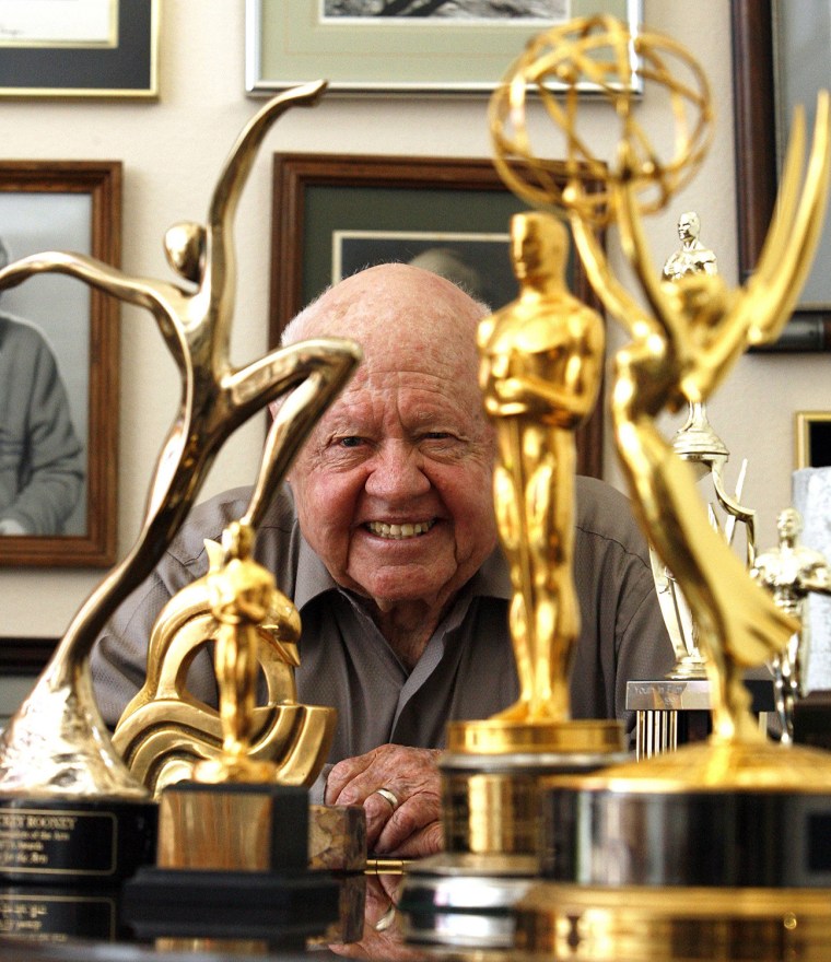 Image: File photo of actor Mickey Rooney smiling in front of his trophies during an interview with Reuters at his home in Westlake Village