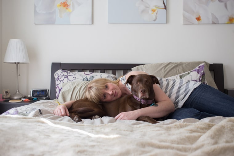 Aila Domstrap (sp) cuddles with Quinn, her three-year-old Lab/Weimeraner mix in their Maryland home.