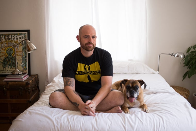 Jim Bob Strothers of Arizona sits on the bed with his 14-year-old Boxer Punky.