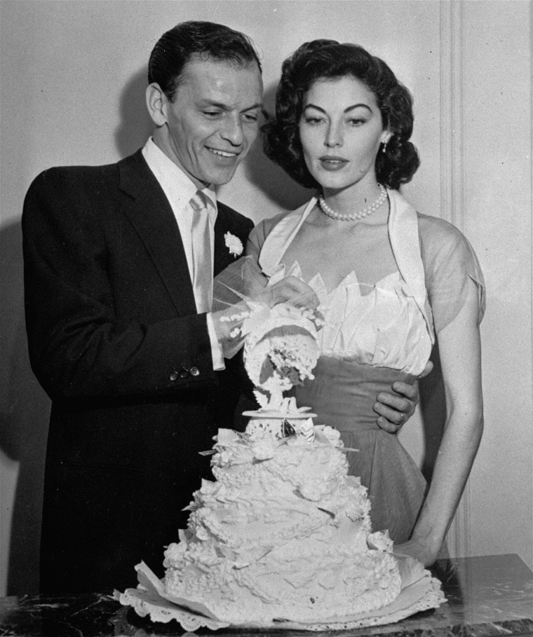 Singer Frank Sinatra and screen actress Ava Gardner cut their wedding cake following their marriage in Philadelphia, November 7, 1951.  The double ring ceremony was performed in the home of a recording company executive. (AP Photo)