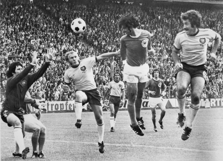 West German forward Gerd Mueller (C) scores on a h