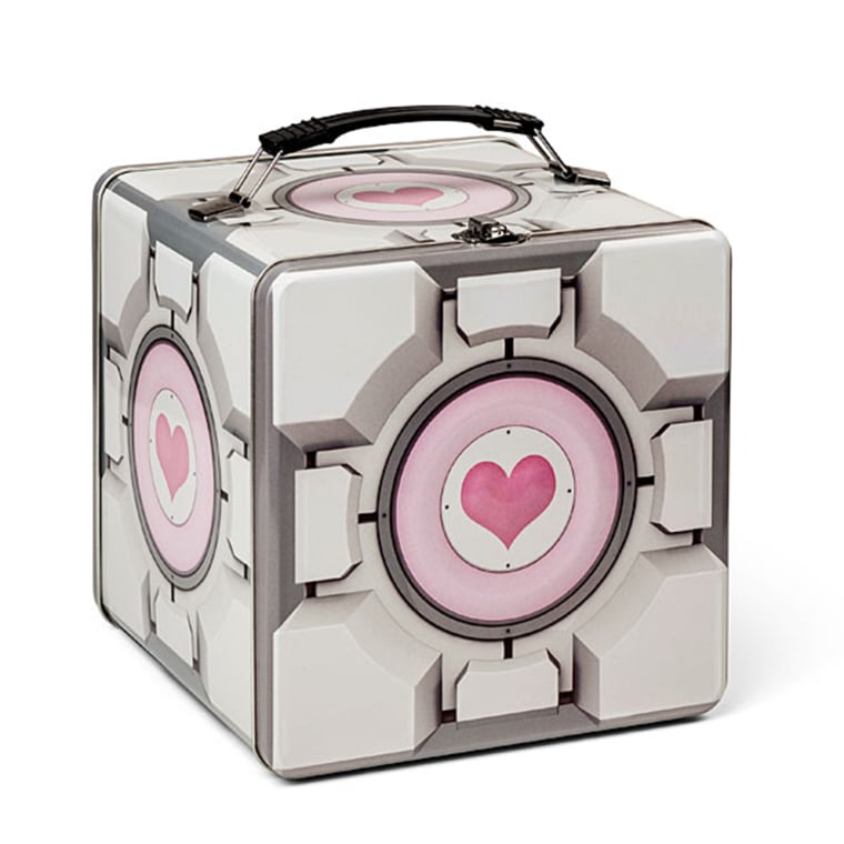 Portal 2 Companion Cube Tin Lunch Box

NO BULLETS WILL GET TO THAT SOUP!

It happens often: you're running around with your portal gun, holding onto the companion cube for dear life while hundreds of rounds of bullets bounce off your friend as he protects you. You see your destination and realize there's a half dozen turrets pointed in that direction. You sprint forward and accidentally throw your companion cube, or drop it. GAME OVER. But the beauty of having the companion cube is that it's tough, it's durable and it's always there with you, even after a test gone horribly wrong.

You're running to class, work, or some place where you have to bring your own lunch. There are no turrets, no incinerators, and no giant pits, but there are other people, the sidewalk, and cars. Someone bumps into you and you slip, launching your precious Portal 2 Companion Cube Tin Lunch Box skyward. Don't fret, it's made of durable tin and as it meets the concrete, it may get a bit scratched up, but its contents are safe